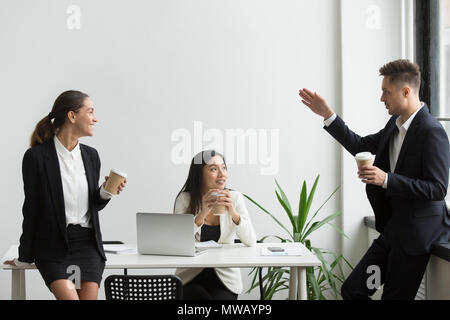 Smiling millennial diverse team people chatting during coffee br Stock Photo