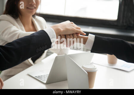 Motivated business people put hands together, loyalty engagement Stock Photo