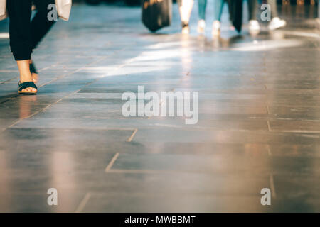 Closeup of peoples legs walking with copy space. Shallow depth of field Stock Photo