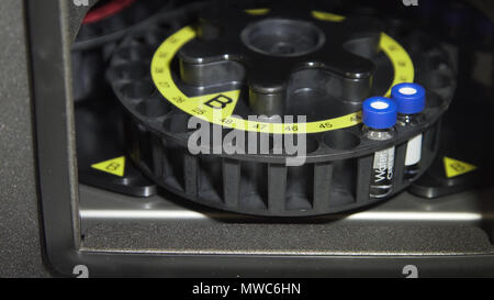 Medical centrifuge for mixing in the laboratory. Tubes prepared in lab centrifuge machine . Modern technologies in medical equipment Stock Photo