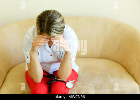 Crying unhappy upset medical nurse. Doctor sad and depressed having stress breakdown. Stock Photo