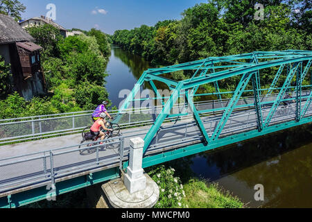 Pedestrian bridge across the Elbe Canal River at Kolin, Czech Republic People crossing the bridge of the old branch of the river waterway Stock Photo