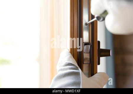 Construction worker installing window in house. Handyman fixing the window with screwdriver Stock Photo