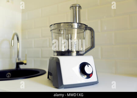 Electric food processor on kitchen countertop, kitchen sink on the background. Easy and fast cooking, kitchen applience concept Stock Photo