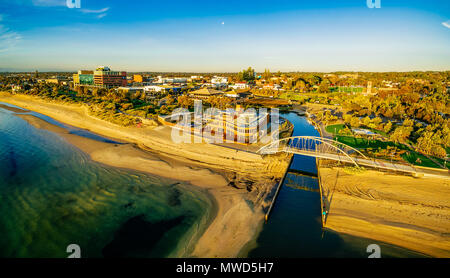 Frankston waterfront at sunset showcasing the famous footbridge over Kananook creek - aerial panorama. Melbourne, Australia Stock Photo