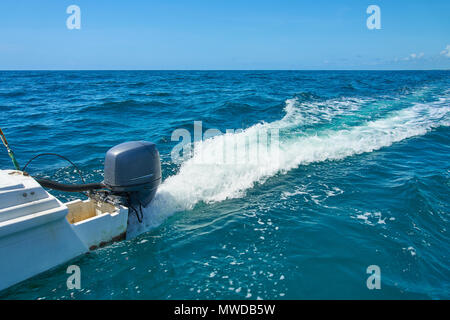 Trail on water surface behind of fast moving motor catamaran in the Caribbean Sea Cancun Mexico. Summer sunny day, blue sky with clouds Stock Photo