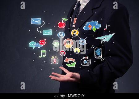 Colorful hand-drawn social media icons in the hands of a businessman Stock Photo