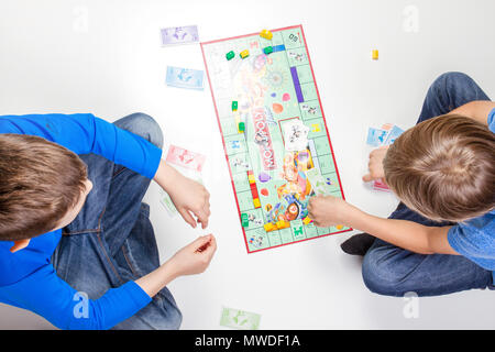 Children playing board game Monopoly Stock Photo