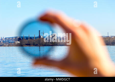 City through a polarizing filter in the female hand Stock Photo