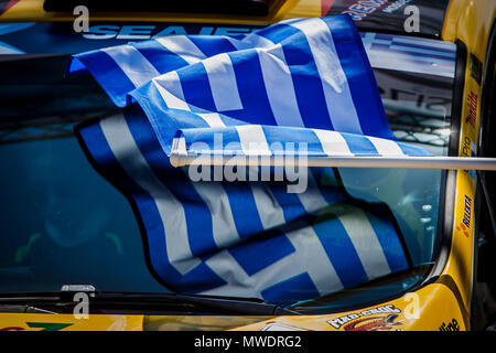 Athens. 1st June, 2018. A Greek flag waves to sign the start of a racing car at the starting line of the Acropolis Rally 2018 at the foot of Acropolis hill in Athens, Greece, 1 June 2018. Credit: Panagiotis Moschandreou/Xinhua/Alamy Live News Stock Photo