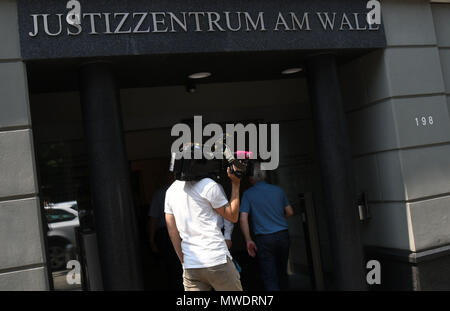 01 June 2018, Germany, Bremen: Journalists enter the justice centre 'Am Wall', where the labour and employment court is located. A translator is sueing his former employer BAMF, the German Office for Migration and Refugees, for terminating his employment. The labour court has scheduled a conciliation hearing. The plaintiff himself did not appear in court. Photo: Carmen Jaspersen/dpa Stock Photo