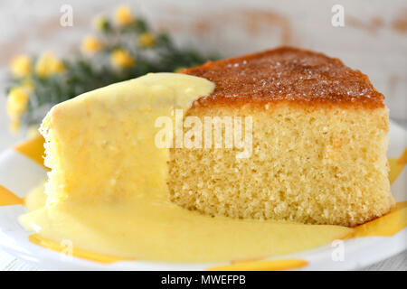 close up of lemon sponge pound cake showing a slice  selective focus in background  to add copy space Stock Photo