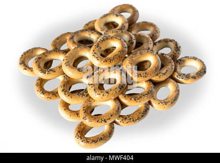 A photo of bagels with poppy seeds. Bagels are stacked in a pyramid. Isolated photo on the white background for site about kitchen, food, traditions. Stock Photo