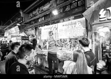 Xian, China - October 5, 2017: Street food vendor at the Muslim Quarter, well-known tourism site famous for its culture and food. Stock Photo