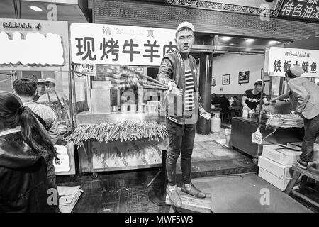 Xian, China - October 5, 2017: Street food vendor at the Muslim Quarter, well-known tourism site famous for its culture and food. Stock Photo