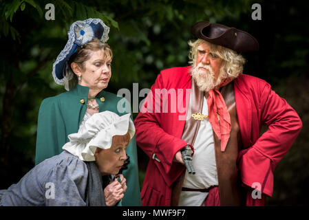 Acting - An amateur drama group in a performance at Trebah Garden Amphitheatre in Cornwall. Stock Photo