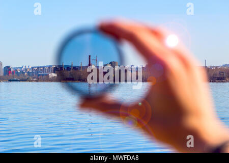 City through a polarizing filter in the female hand Stock Photo