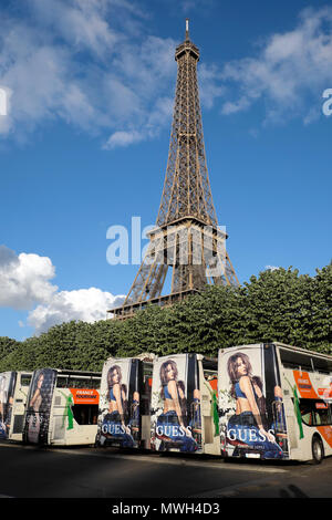 singer actor Jennifer Lopez photo on Guess fashion advertisement on tour buses parked at the Eiffel Tower Paris, France KATHY DEWITT - Alamy