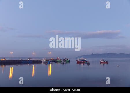 Chonchi, Chiloé, Chile: A view of the harbor at dusk, in Chonchi. Stock Photo