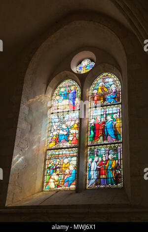 The sun's rays pass through the stained glass window in Saint Quiriace Collegiate Church (Collégiale Saint-Quiriace de Provins), Provins, France. Stock Photo