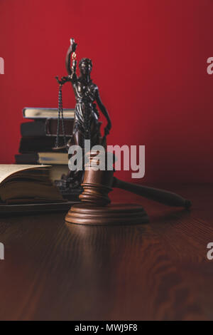 opened juridical books with lady justice statue and gavel on wooden table, law concept Stock Photo