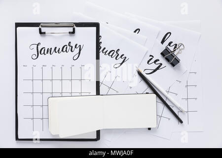 top view of arrangement of office supplies and calendar isolated on white Stock Photo