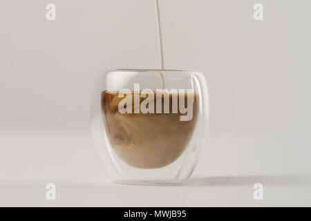 https://l450v.alamy.com/450v/mwjb95/pouring-milk-in-cup-with-coffee-isolated-on-white-background-mwjb95.jpg