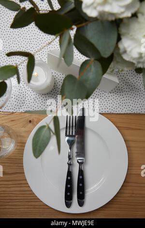 Empty White Plate And Cutlery On A Napkin Flat Lay On White Background