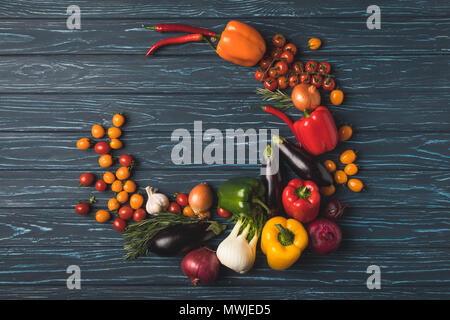 top view of round of ripe organic vegetables on wooden table Stock Photo