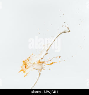 two splashes of milk and coffee, isolated on white Stock Photo