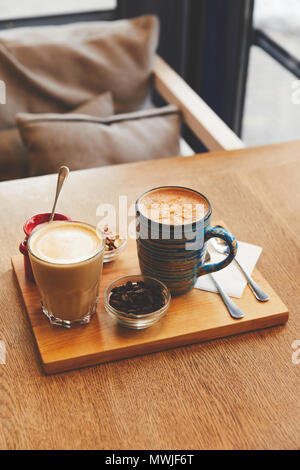 Coffee beverages with milk on cafe table Stock Photo