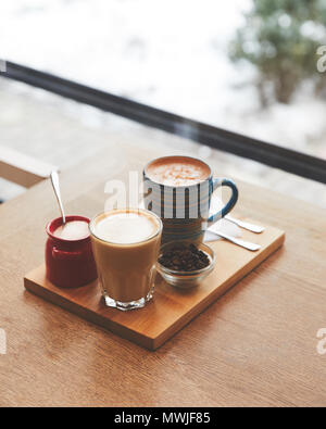 Hot coffee with milk in table in coffee shop Stock Photo