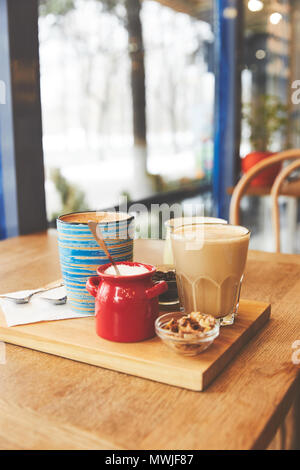 Restaurant table with coffee served in glass and cup Stock Photo