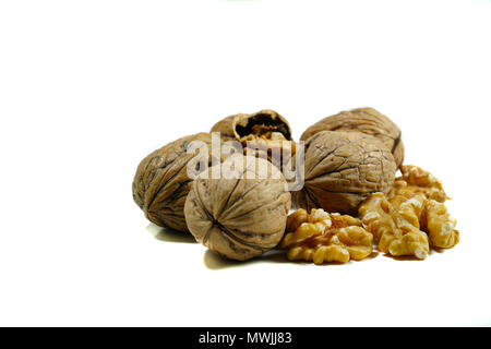 Kernel walnuts and whole walnuts on isolated white background Stock Photo