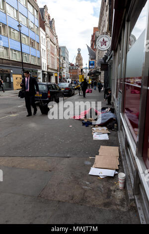 London, United Kingdom, April 18, 2018: A homeless man sleeps on the pavement in the centre of London. Homelessness is considered a major and growing  Stock Photo