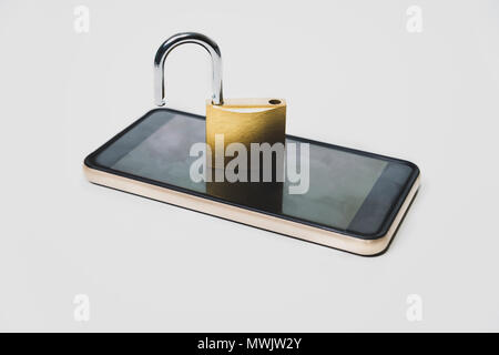 Open padlock and telephone. Cybercrime, cybersecurity, hackers, hacking the phone, no security in the phone. There is a mobile phone on the table with Stock Photo