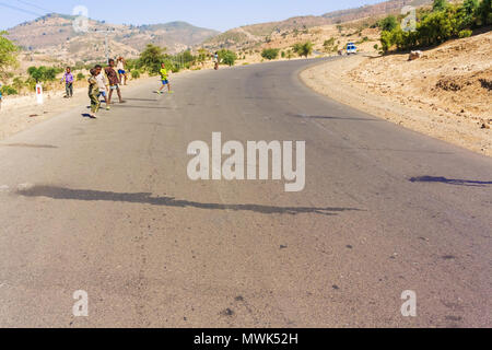 Addis Zemen, Ethiopia - February 10, 2015: Ethiopian children playing on the road near Addis Zemen in Ethiopia. Stock Photo