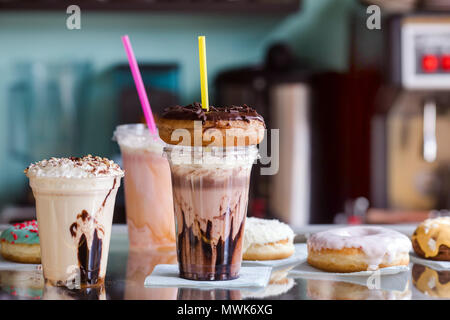 Milkshakes with donuts for takeaway in a cafe Stock Photo