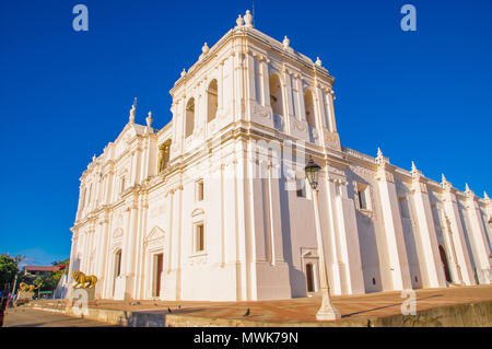 LEON, NICARAGUA, MAY, 16, 2018: Outdoor view of white building structure of Catedral de la Ascuncion de Maria, Mary's Assumption Cathedral in a gorgeous sunny day and blue sky background Stock Photo