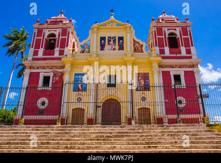 LEON, NICARAGUA, MAY, 16, 2018: Church with yellow facade blending pure neo classical lines and baroque decoration, flanked by two side towers painted fake bricks, Leon Stock Photo