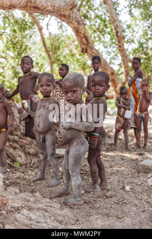 NAMIBE/ANGOLA - 28 AUG 2013 - African boys belonging to an angola tribe from southern angola known by himbas. Stock Photo