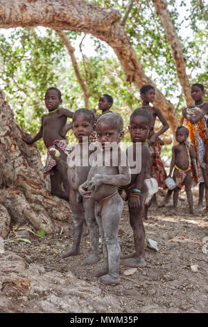 NAMIBE/ANGOLA - 28 AUG 2013 - African boys belonging to an angola tribe from southern angola known by himbas. Stock Photo