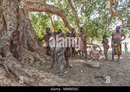 NAMIBE/ANGOLA - 28 AUG 2013 - African boys belonging to an angola tribe from southern angola known by himbas. Stock Photo