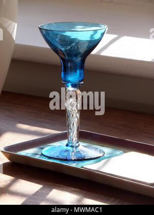 Blue crystal glass by a window Stock Photo