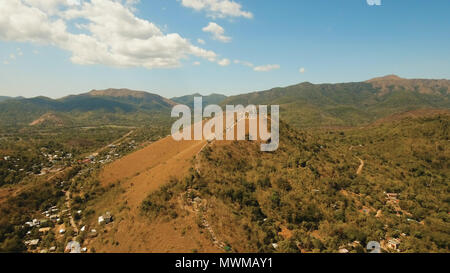 The sign of the city of Coron is on a hill, a famous tourist place. Aerial view: Catholic cross on a hill, mountain in the town of Coron, Philippines,Palawan Busuanga. Travel concept. Stock Photo