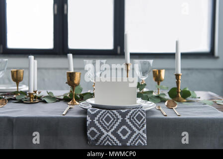 close up view of empty card on plates on tabletop with beautiful rustic setting for guests Stock Photo