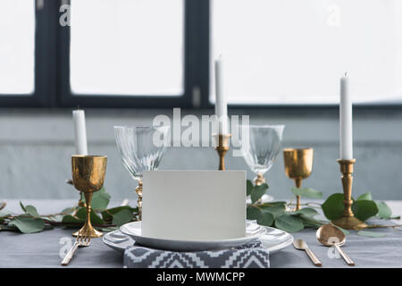 close up view of empty card on plates on tabletop with beautiful rustic setting for guests Stock Photo