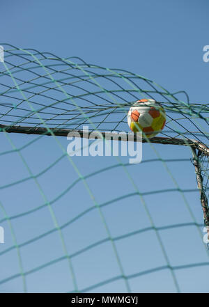 Football hitting the back of a football goal Stock Photo