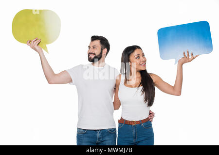 Portrait of couple looking at blank speech bubbles in hands isolated on white Stock Photo