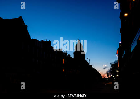 Silhouette of buildings near George Street, located in Edinburghs New Town, against a dark blue sky during sunset Stock Photo